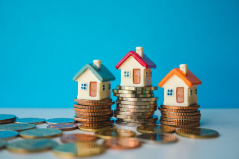Miniature colorful house with stack coins