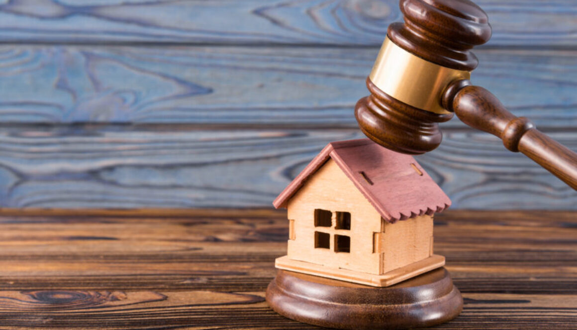 wooden house, judge's gavel on wooden background