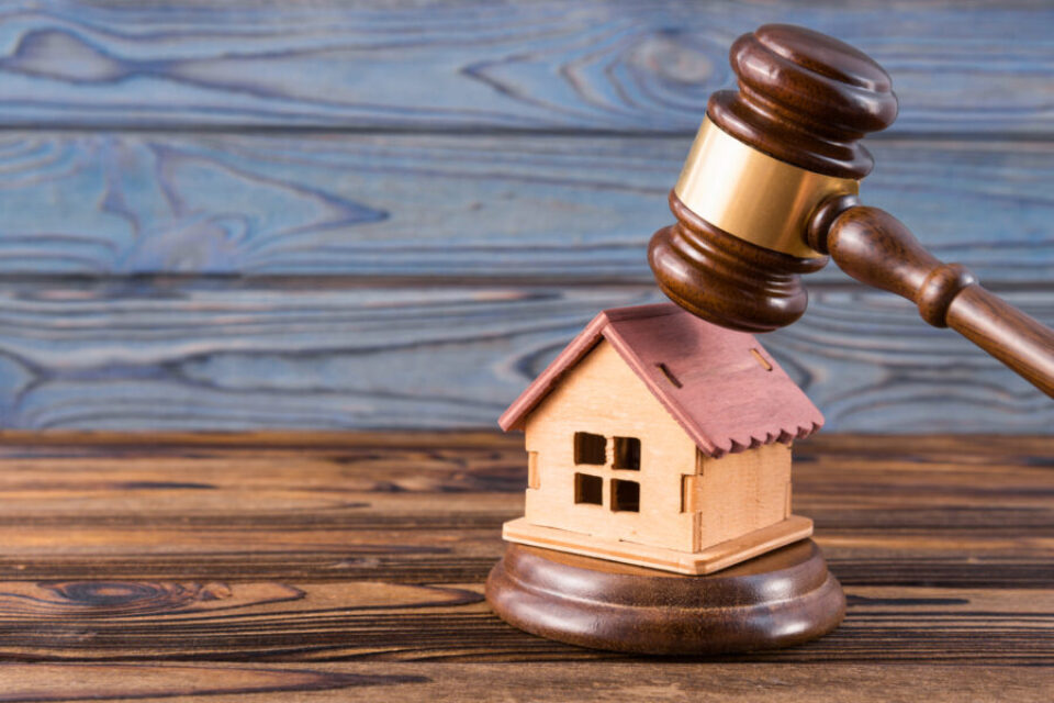 wooden house, judge's gavel on wooden background