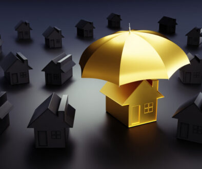 Golden toy house under an umbrella