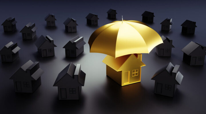 Golden toy house under an umbrella