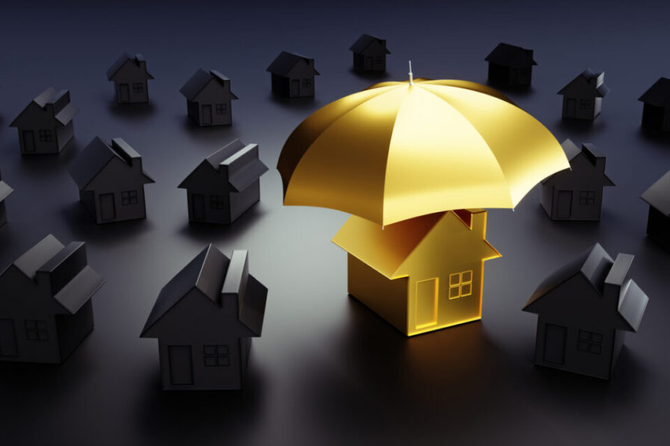 Golden toy house under an umbrella