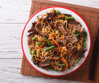 Chinese noodles with beef, muer and vegetables. Horizontal top view