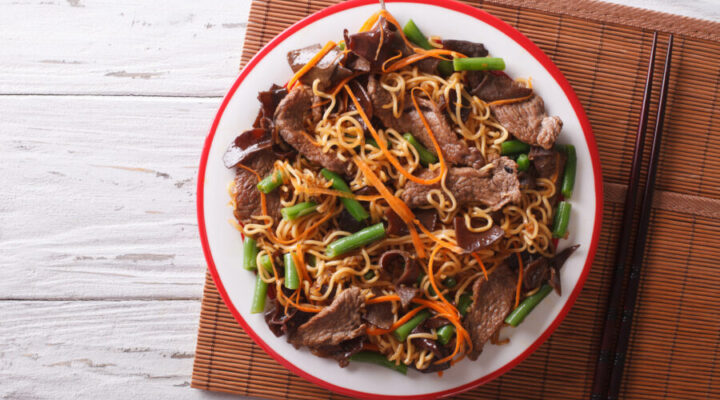 Chinese noodles with beef, muer and vegetables. Horizontal top view