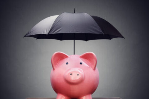 Financial insurance or protection piggy bank with umbrella