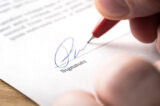Signing contract, lease or settlement for acquisition, apartment lease, insurance, bank loan, mortgage or business buyout. Man writing name and autograph with pen. The signature is made up.