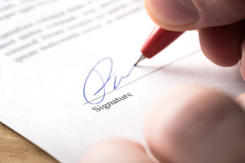Signing contract, lease or settlement for acquisition, apartment lease, insurance, bank loan, mortgage or business buyout. Man writing name and autograph with pen. The signature is made up.